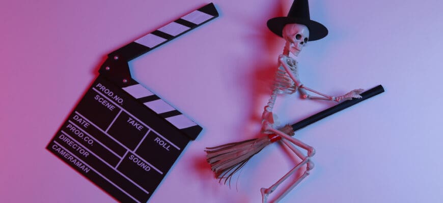 Movie,Clapperboard,With,Witch,Skeleton,On,Broomstick,In,Gradient,Neon